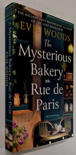 Load image into Gallery viewer, THE MYSTERIOUS BAKERY ON THE RUE DE PARIS - Evie Woods
